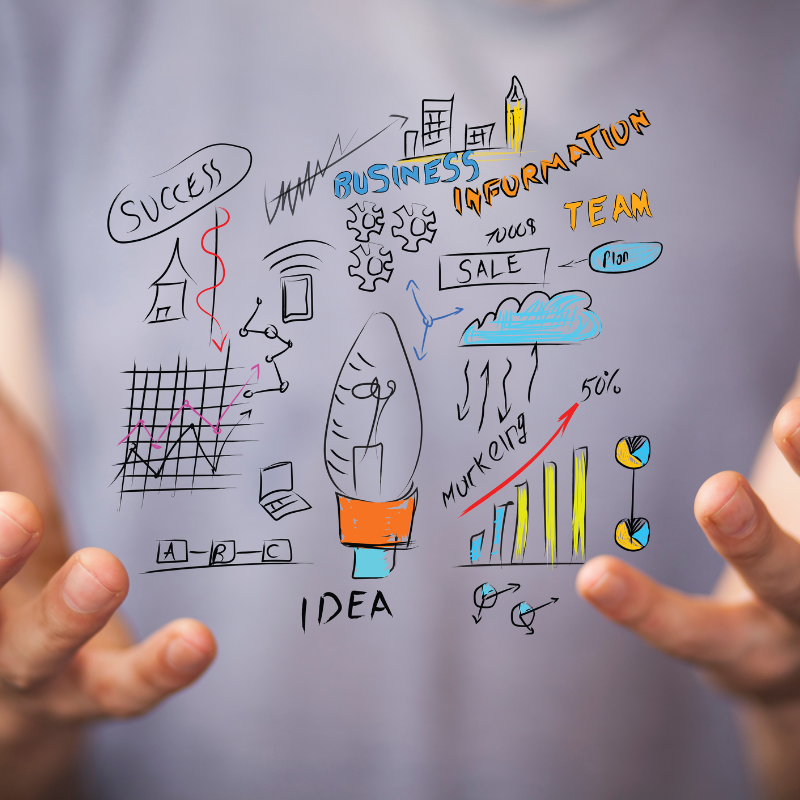 Man with a white shirt and hands outstretched with doodled ideas printed on the screen.